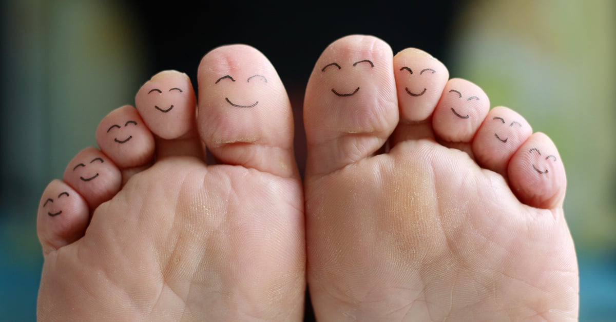 Toes with smiley faces drawn on them