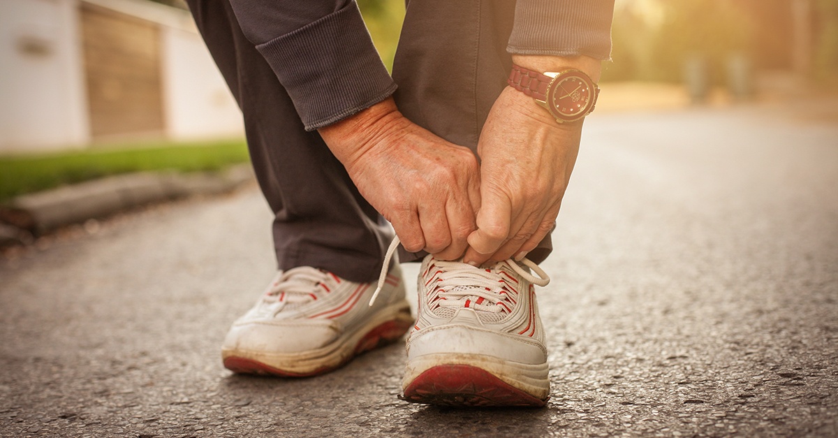 Senior woman tieing shoe lace