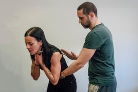 Man and woman demonstrating the American Red Cross "five-and-five" method for choking