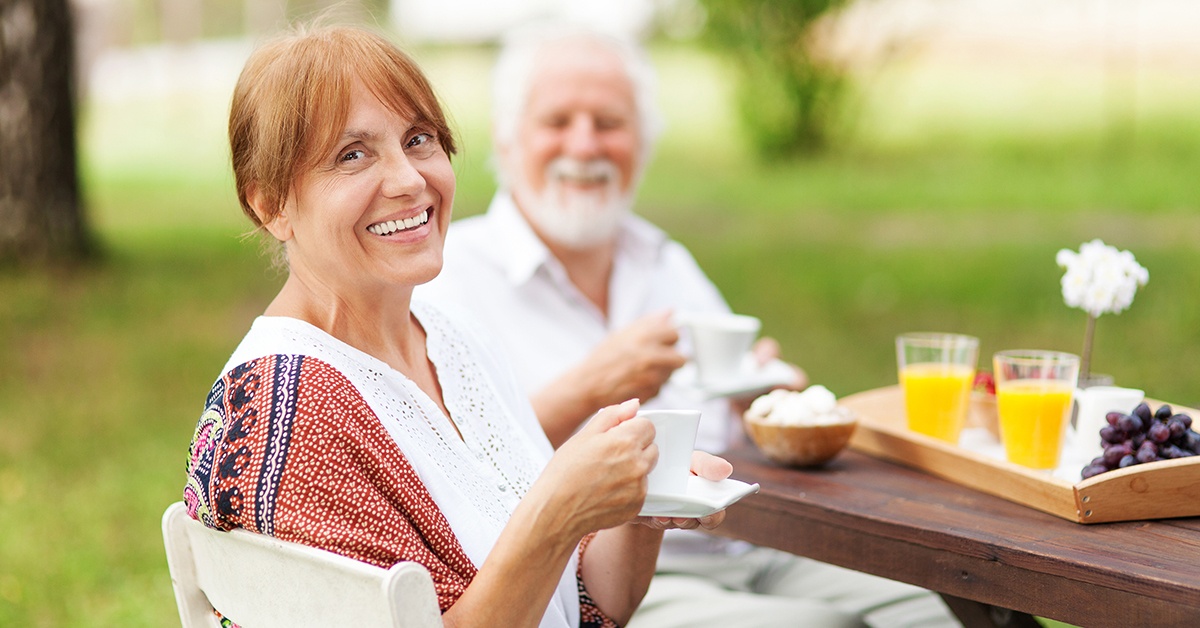 Senior Couple eating breakfast outside